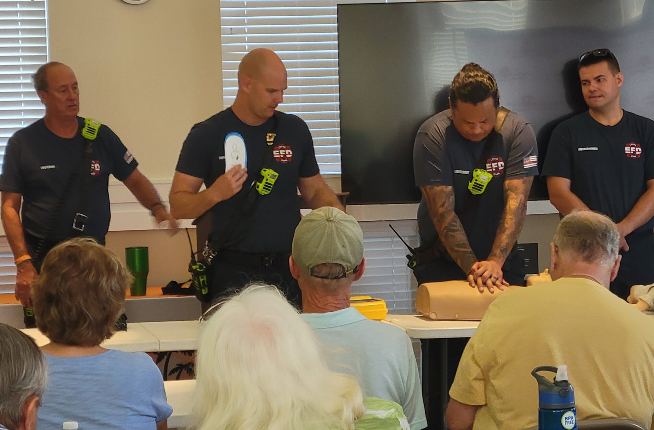 Four Firefighters showing CPR technique